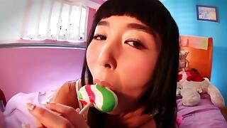 Asian porn star plays with a candy cock